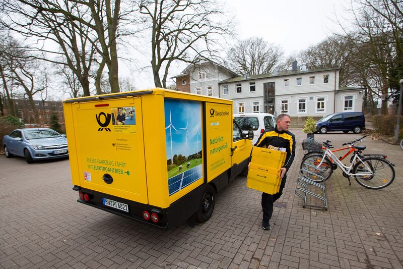 A Deutsche Post employee uses a StreetScooter to make a postal delivery in Hamburg, Germany.