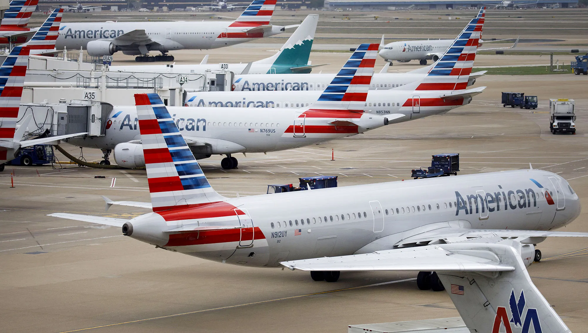 American Airlines Group Inc. planes stand at Dallas-Fort Worth International Airport (DFW) in Grapevine, Texas, U.S., on Friday, April 6, 2018.