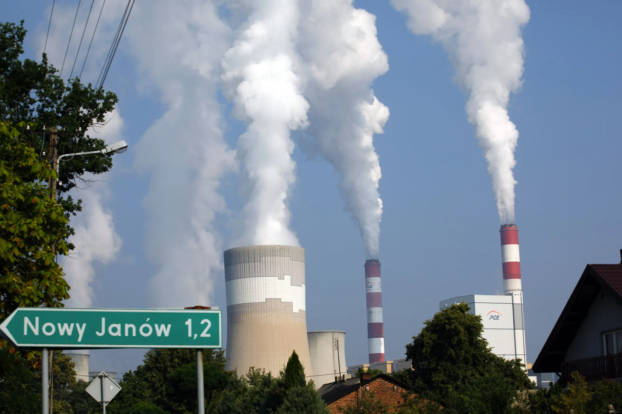 Vapor rises from the cooling tower and chimneys of the Belchatow coal powered power plant in Poland.