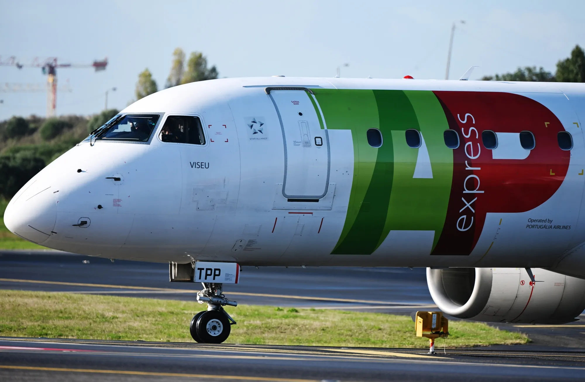 A logo on the fuselage of a TAP SA aircraft at Humberto Delgado airport in Lisbon.