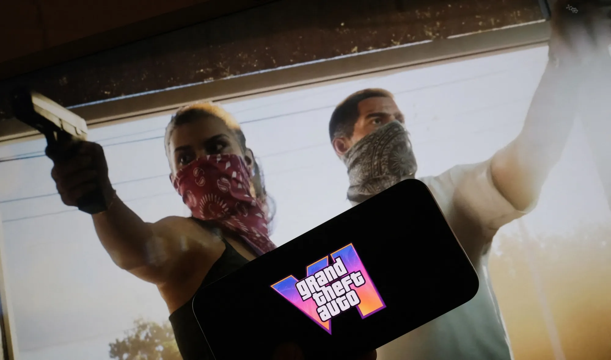 This illustration photo created in Los Angeles, December 4, 2023, shows Rockstar Games' Grand Theft Auto VI trailer played on a screen in front of the game title.