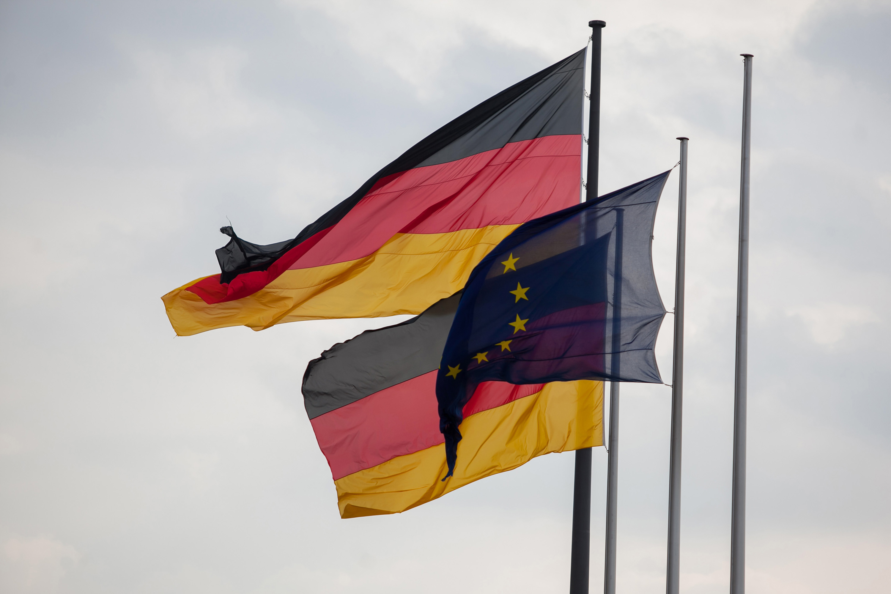 German Flags Fly next to a European Flag in Germany