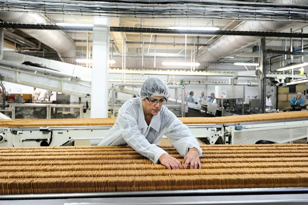 An employee works on a production line in Vertou, western France