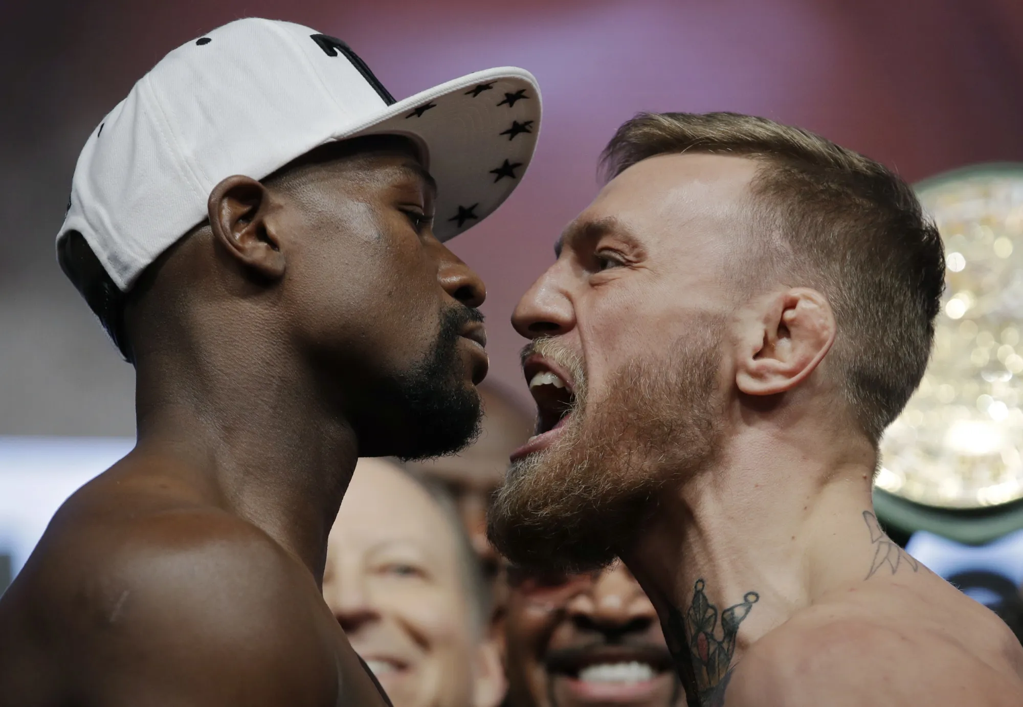 Floyd Mayweather Jr., left, and Conor McGregor face off during a weigh-in Friday, Aug. 25, 2017, in Las Vegas.
