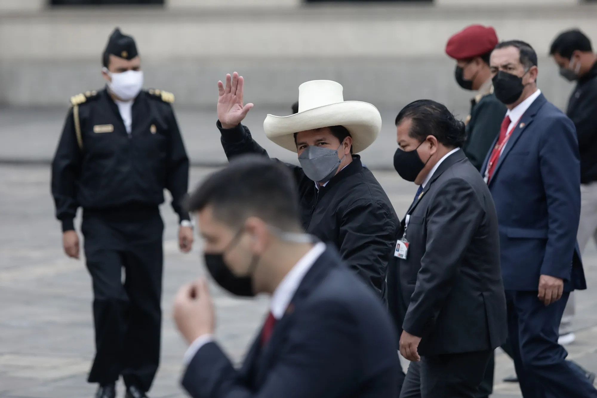 Pedro Castillo, Peru’s president, center, waves after presenting his new cabinet during a ceremony outside the Government Palace in Lima, on&nbsp;Oct. 25, 2021.&nbsp;