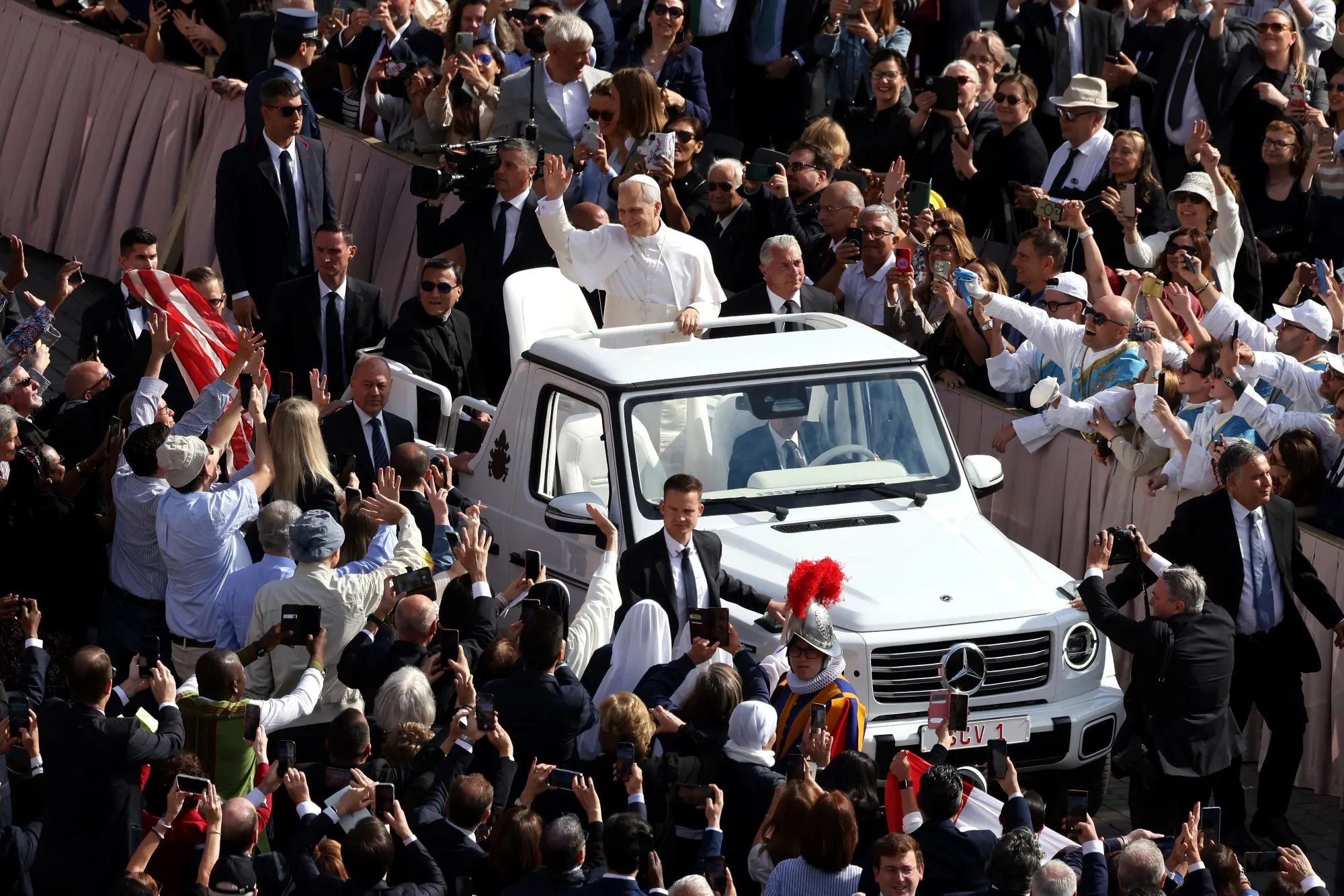 Pope Leo XIV waves to the crowd as he arrives in the Popemobile for his inaugural mass in St. Peter's Square in Vatican City on May 18.
