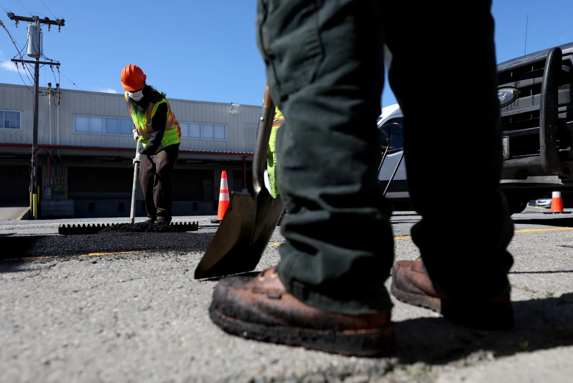 San Francisco Department of Public Works&nbsp;workers&nbsp;repair&nbsp;a pot hole.