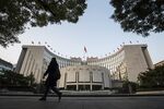 A pedestrian walks past the People's Bank of China headquarters in Beijing.
