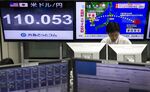 A dealer works in front of monitors displaying the exchange rate of the yen against the U.S. dollar, left, and a news broadcast of North Korea's missile launch at a foreign exchange brokerage in Tokyo, Japan, on Friday, Sept. 15, 2017.