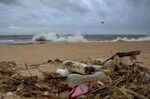 Plastic waste lies among other debris washed ashore on a beach in Sri Lanka.