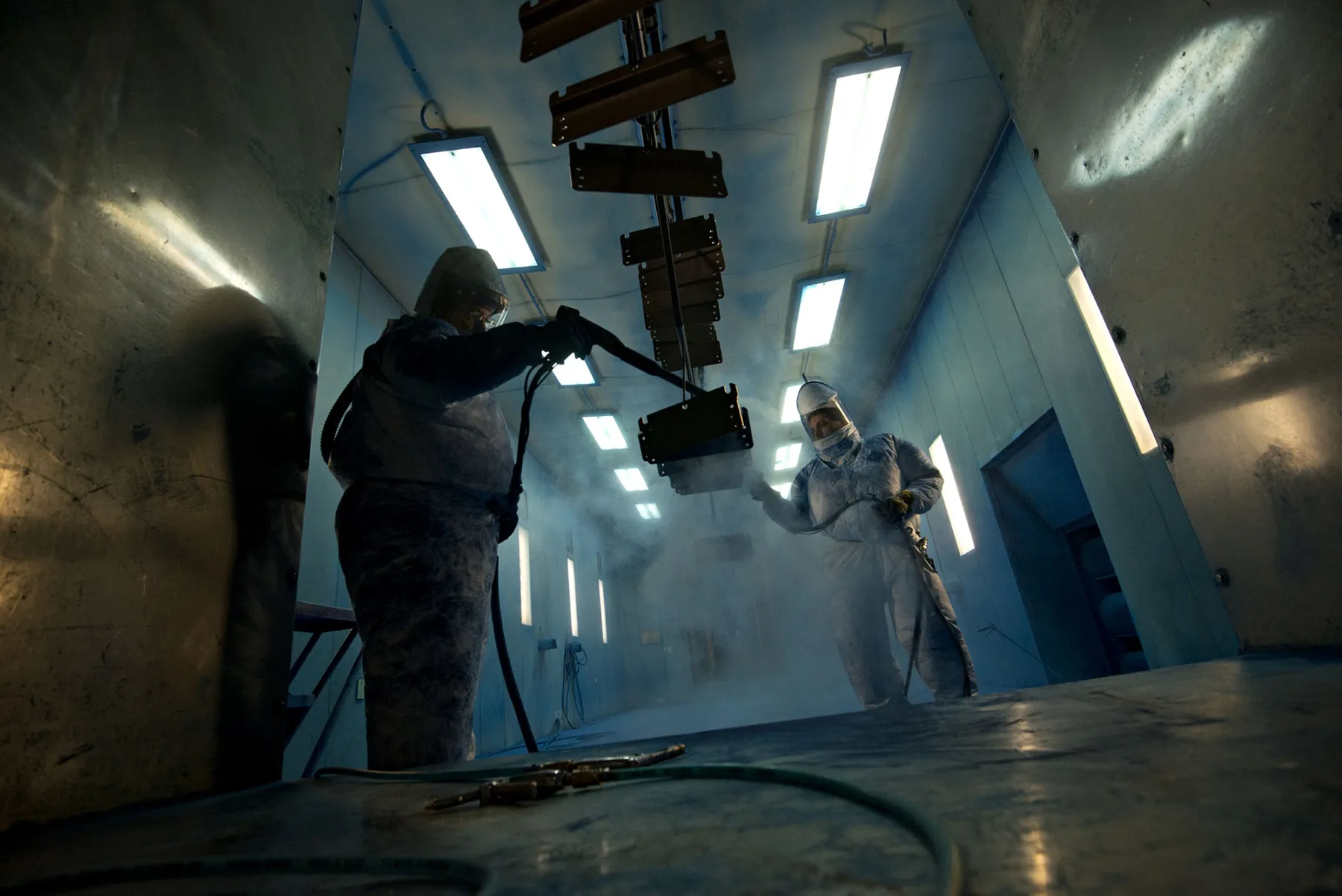 Workers powder-coat components at a factory in Williamsburg, Iowa.