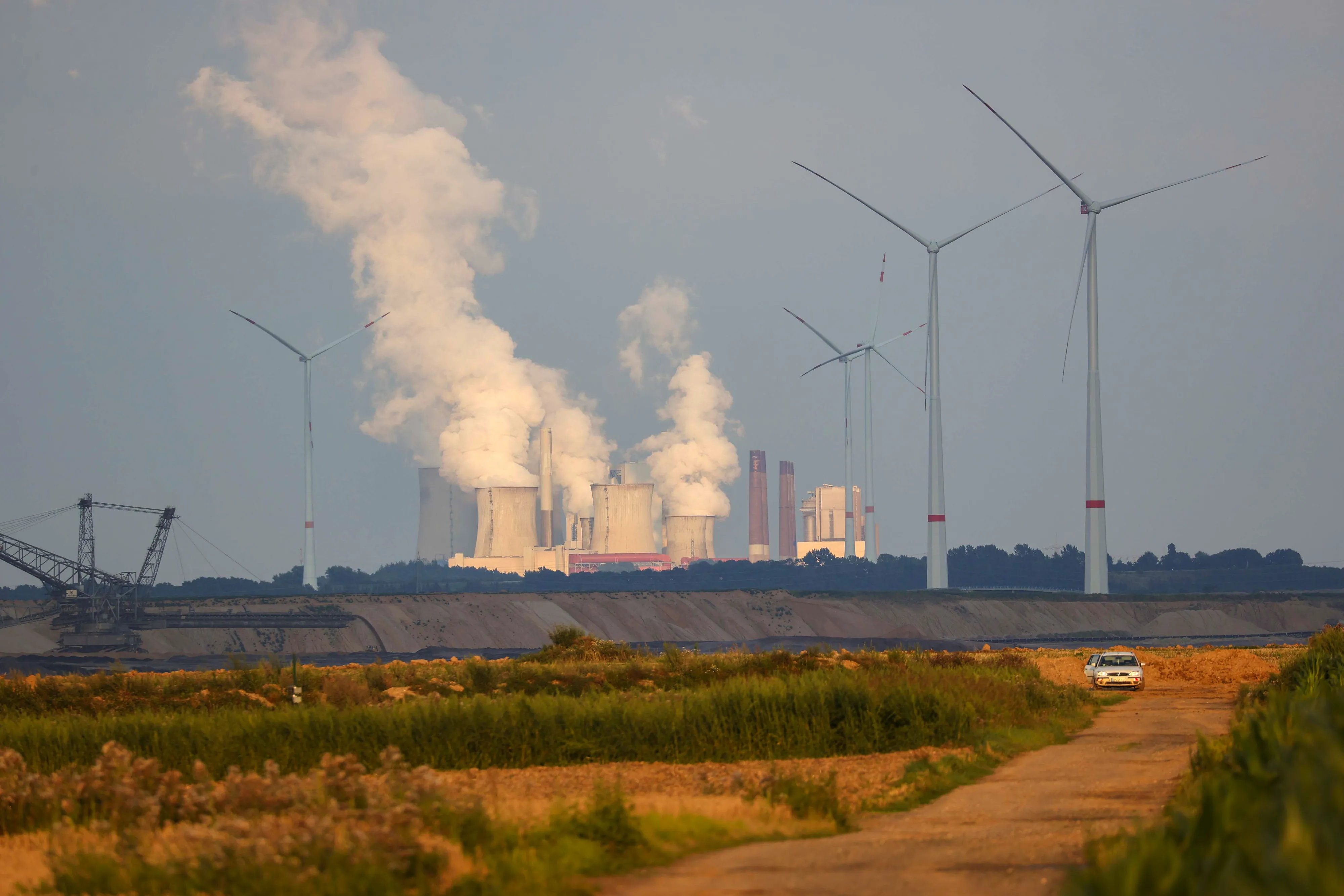 The Niederaussem coal power plant near the Garzweiler lignite mine and wind turbines, operated by RWE AG, in Grevenbroich, Germany.&nbsp;