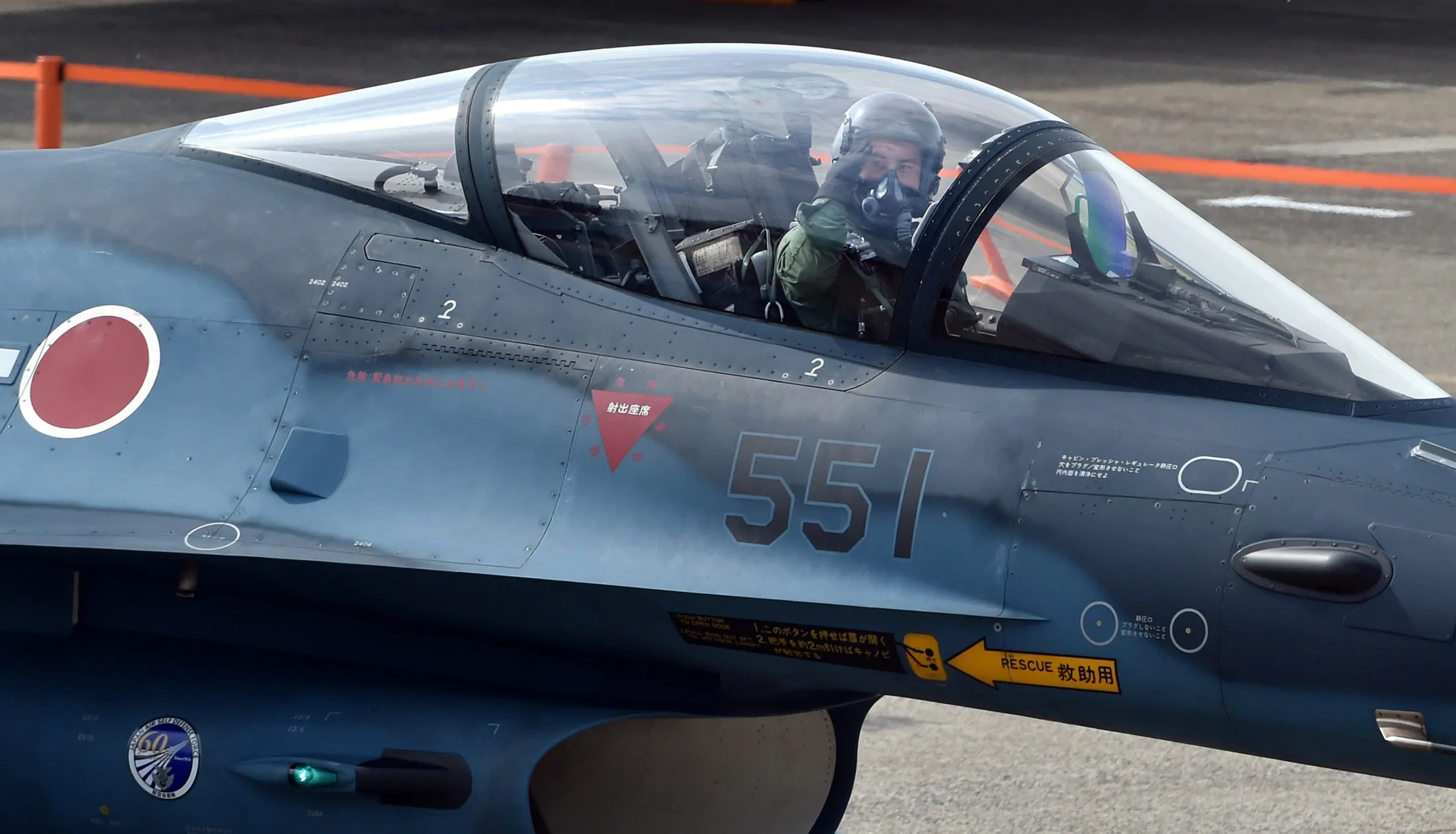 A Japan Air Self-Defense Force fighter pilot salutes during a review ceremony at the Hyakuri air base in Omitama, Japan.
