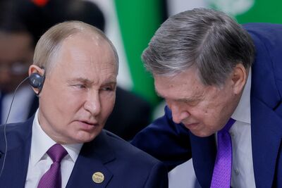 Vladimir Putin and Yuri Ushakov.