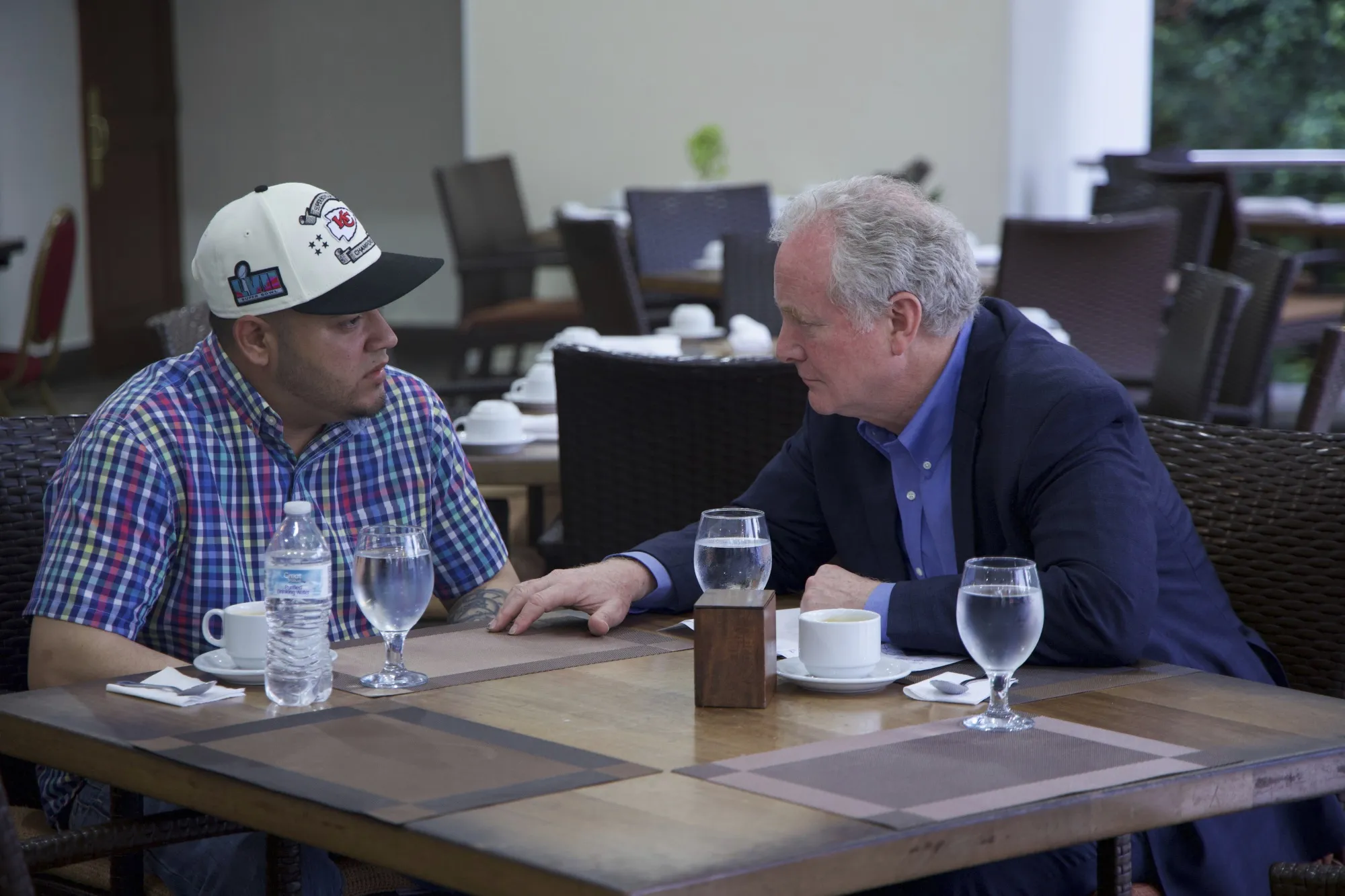 In this photo released by Senator Van Hollen's press office, Hollen, right, speaks with Kilmar Abrego Garcia in a hotel restaurant in San Salvador, El Salvador, on April 17.