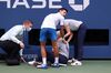 Novak Djokovic tends to a line judge who Djokovic hit in the throat during his Men's Singles fourth round match against Pablo Carreno Busta on Day Seven of the 2020 US Open at the USTA Billie Jean King National Tennis Center in New York on Sept. 6.