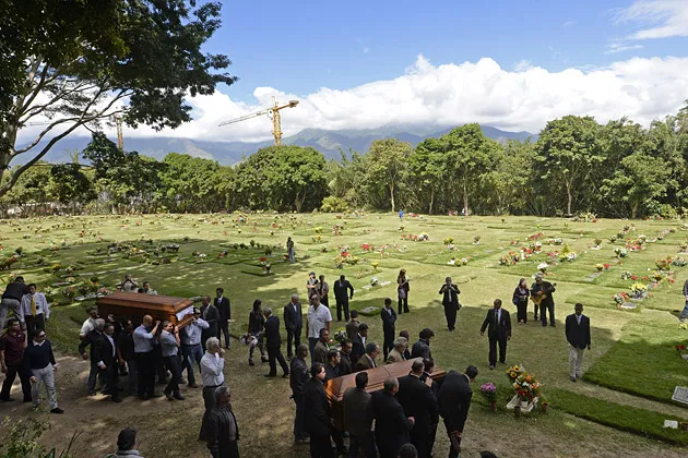 Relatives and friends carry the coffins of Venezuelan model Monica Spear (right) and British-born partner Thomas Henry Berry during their funeral in Caracas on Jan. 10