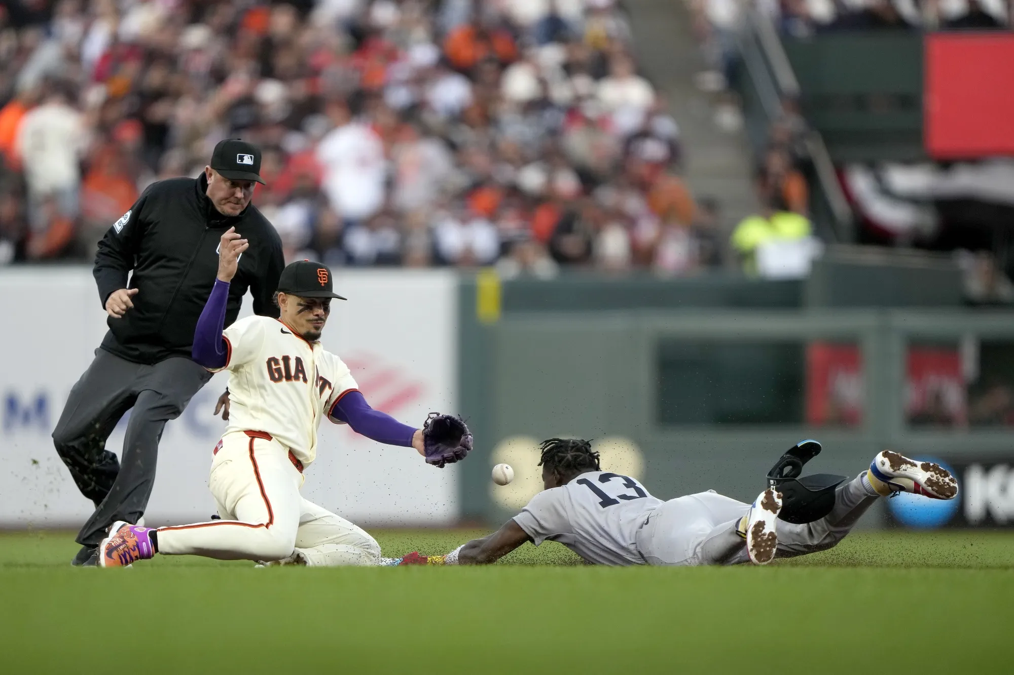 Jazz Chisholm Jr. of the New York Yankees, right, safely steals second base against Willy Adames of the San Francisco Giants during the fifth inning on Opening Day at Oracle Park in San Francisco on March 25.