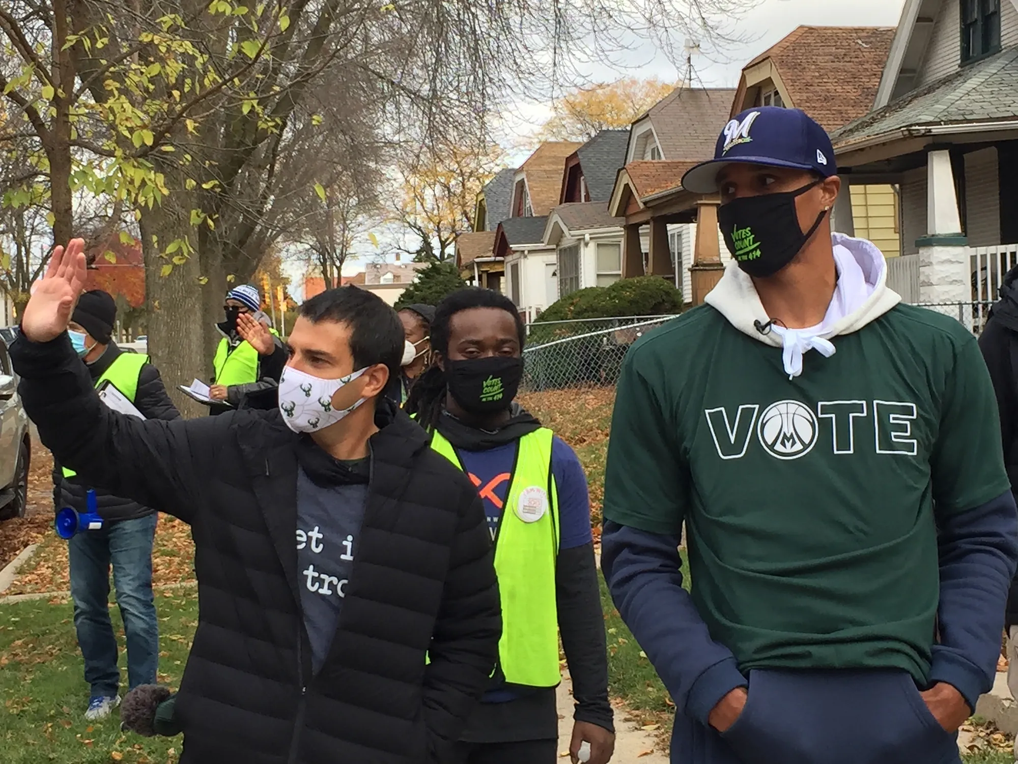 Alex Lasry, left, and then-Bucks guard George Hill walk through a Milwaukee neighborhood during a voter canvassing effort on Oct. 24, 2020.