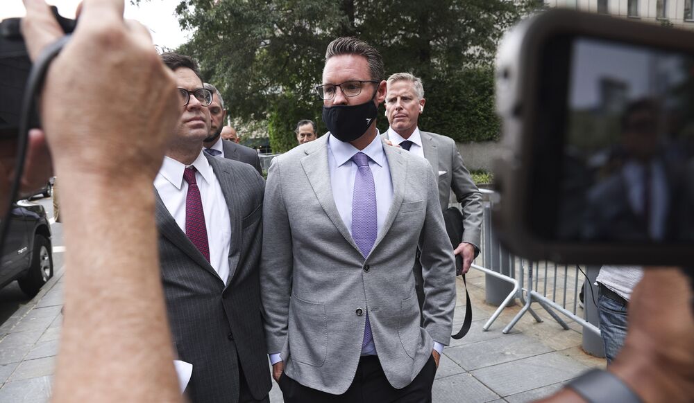 Trevor Milton, center, exits federal court in New York on July 29.