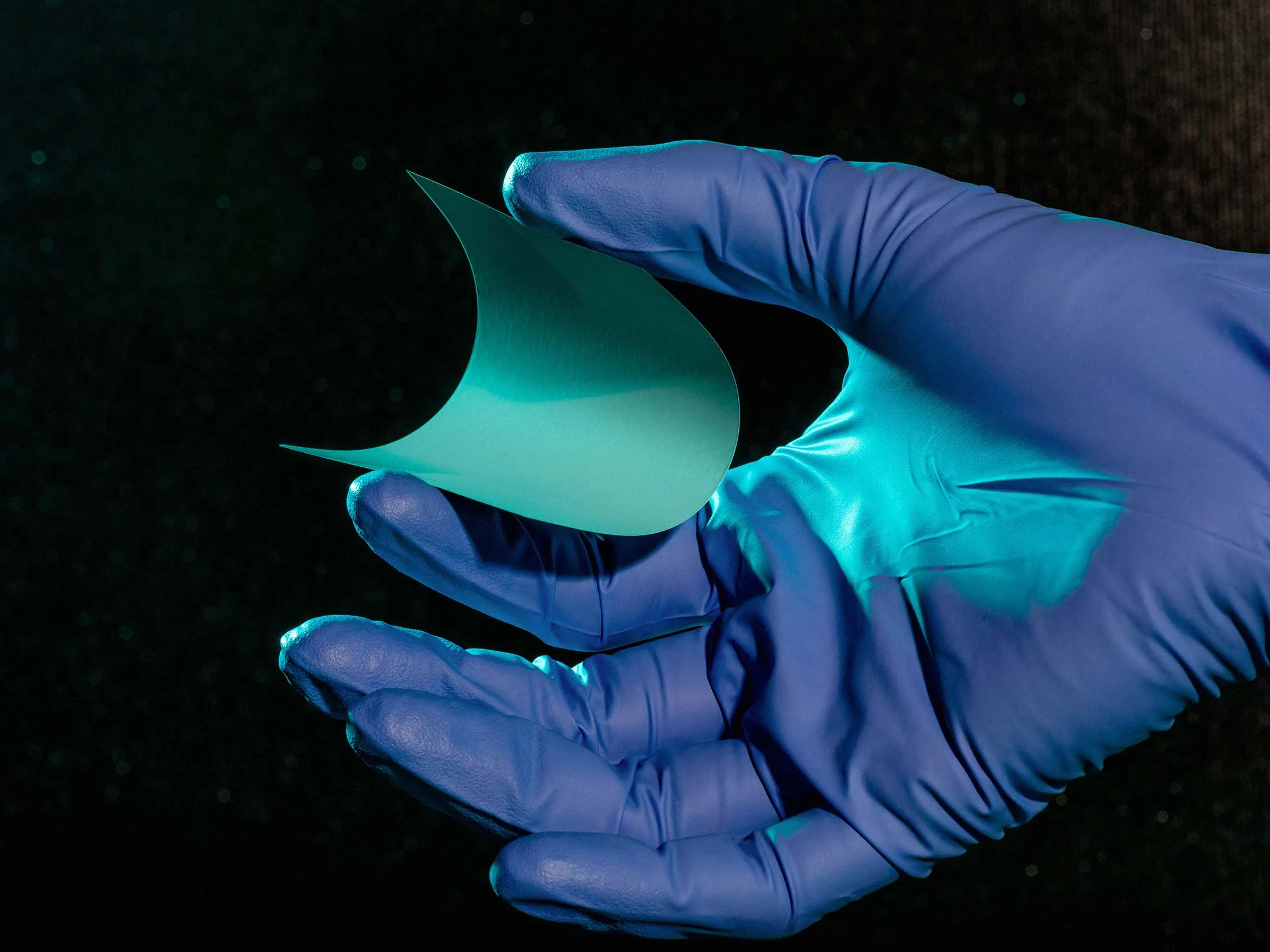 Hand holding QuantumScape’s proprietary ceramic separator that enables fast charge of lithium anodes.