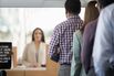 Customers in line to bank counter