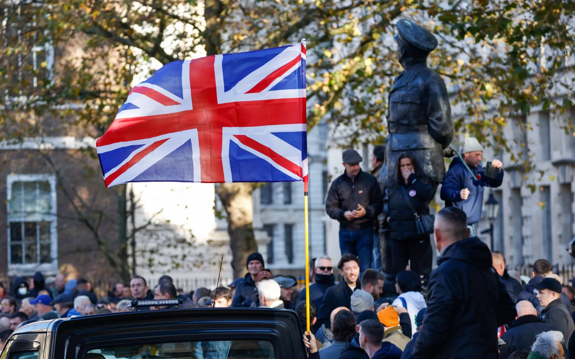 Members of the public with an British Union flag pay their respects&nbsp;on Armistice Day&nbsp;in London&nbsp;on Saturday.