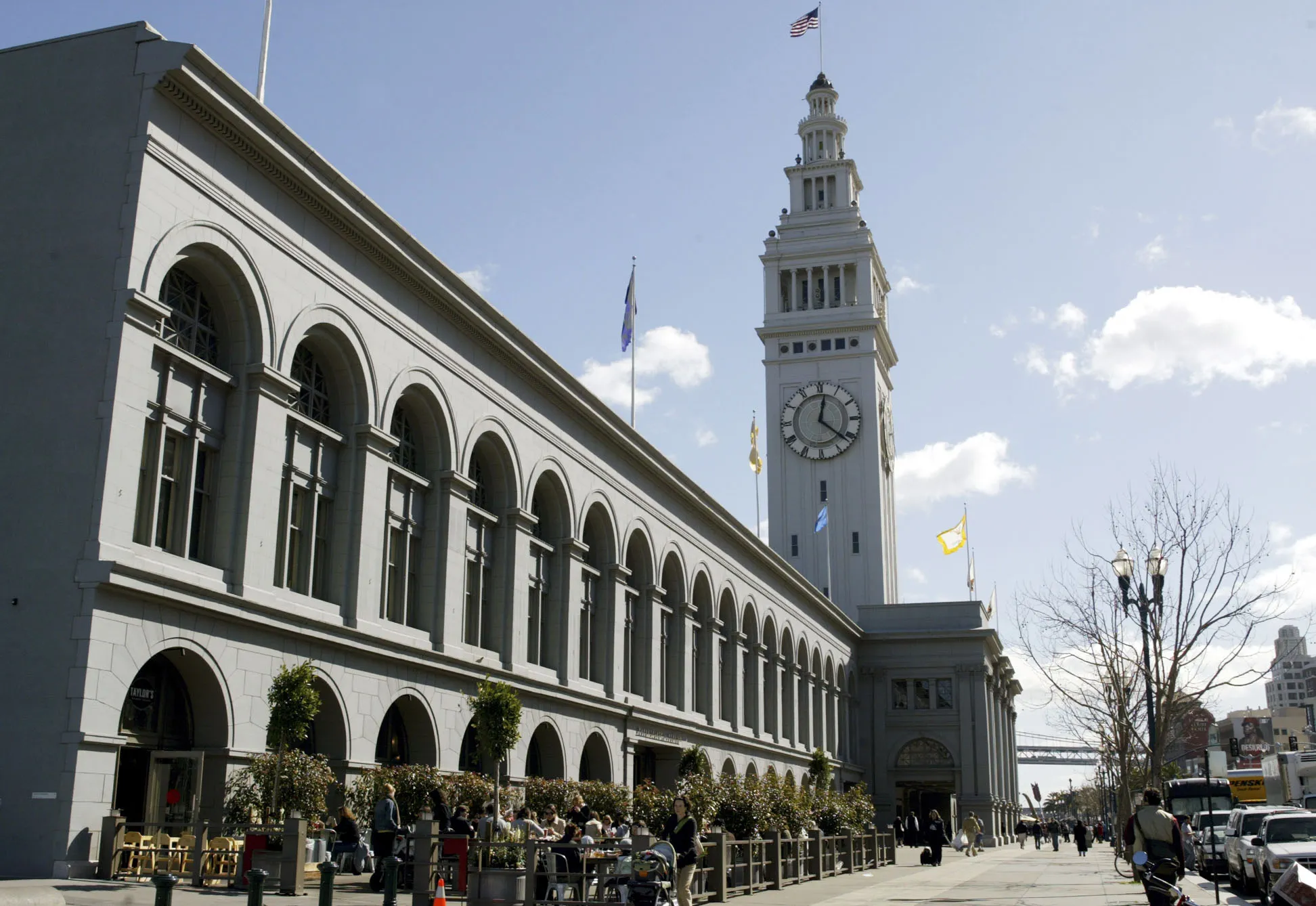 Pedestrians walk outside the Ferry Building in San Francisco, California.