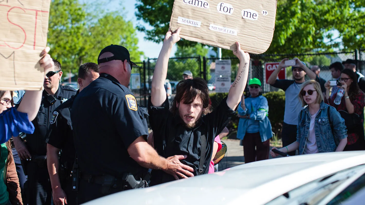 Police officers move protestor Jon Sawyer from blocking vehicles trying to enter an event for Donald Trump in Eugene, Oregon, on May 6, 2016.
