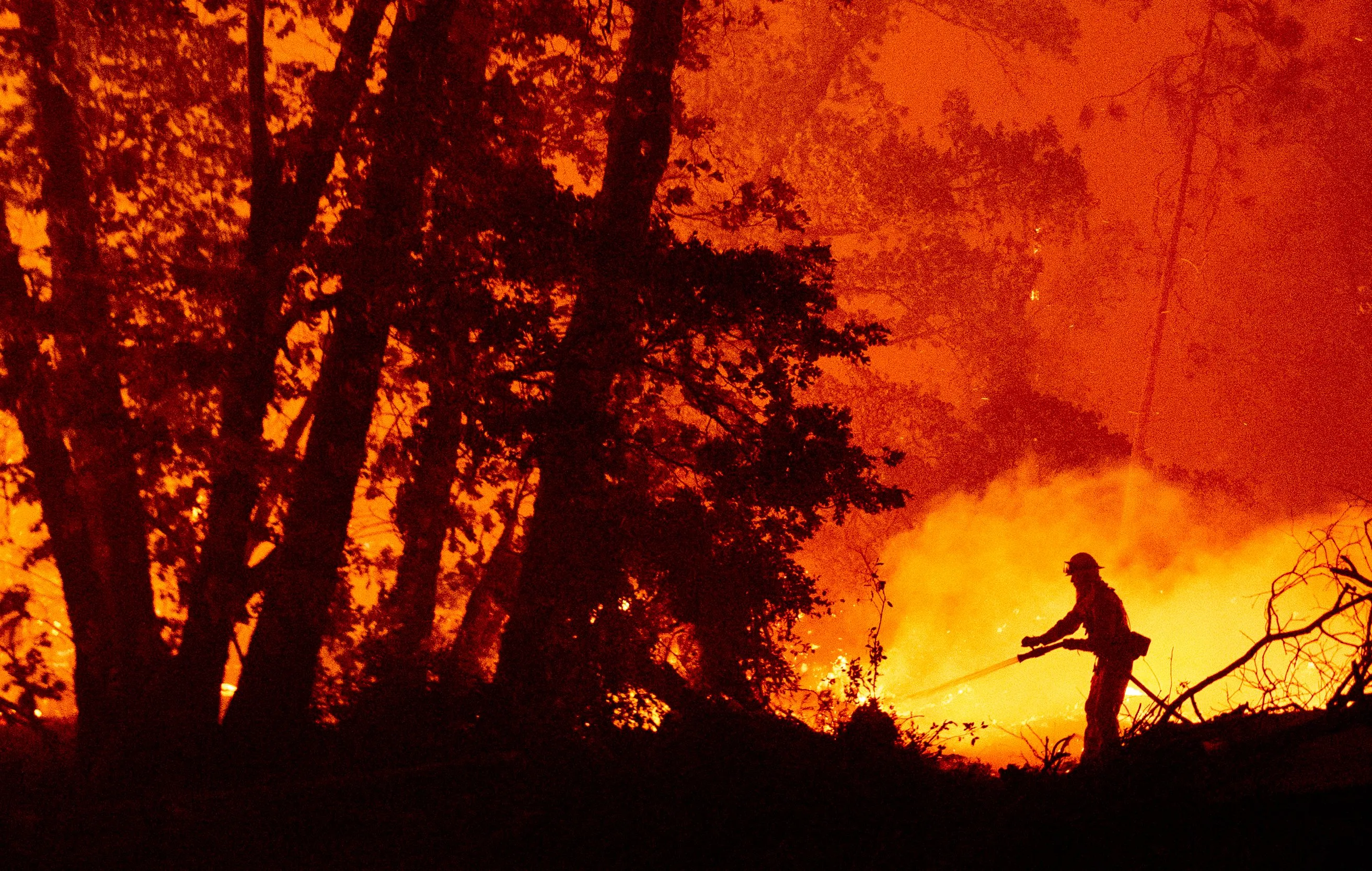 A firefighter battles the Creek fire in Madera County, California.