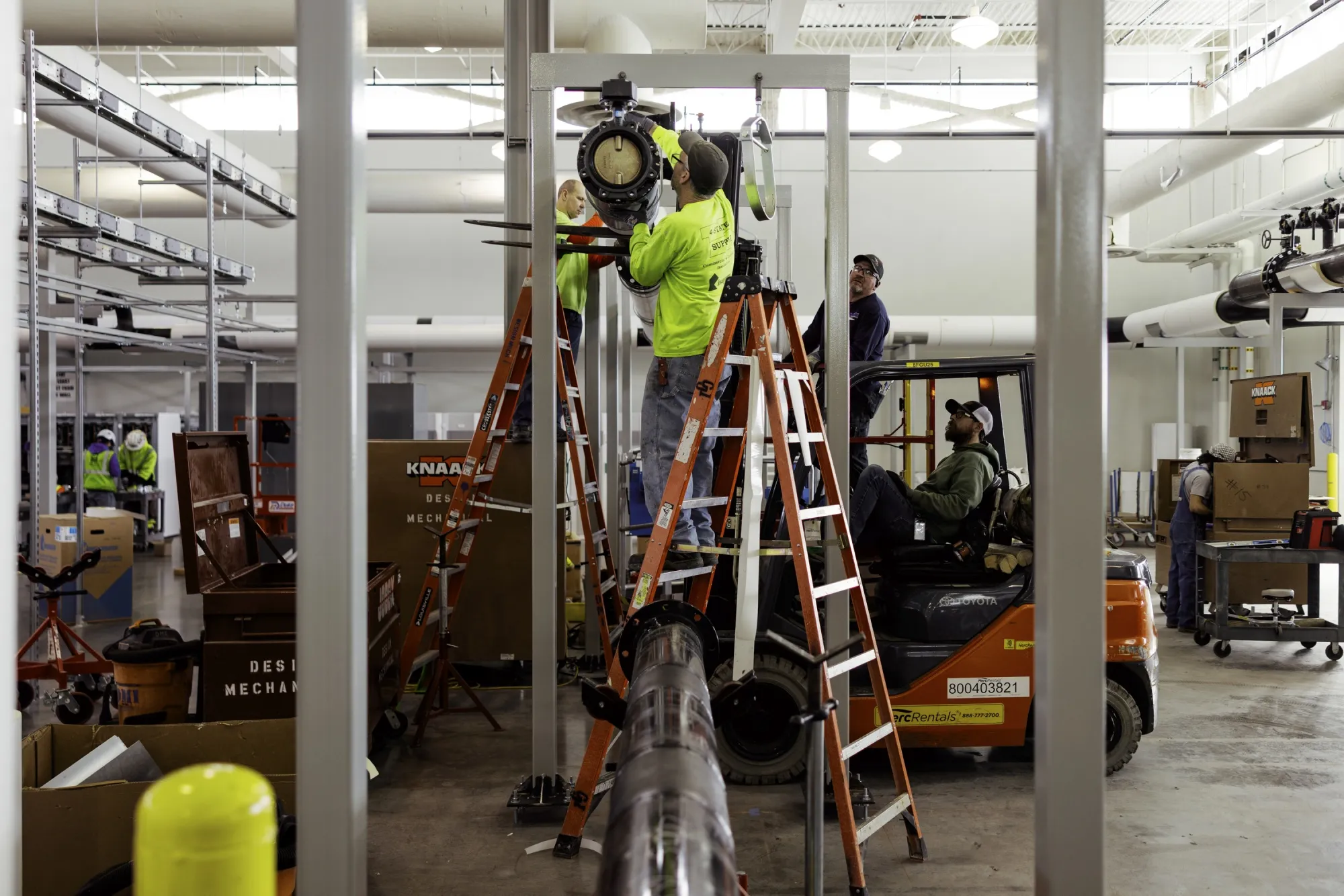 Workers install metal pipe at the Patmos data center in Kansas City, Missouri.