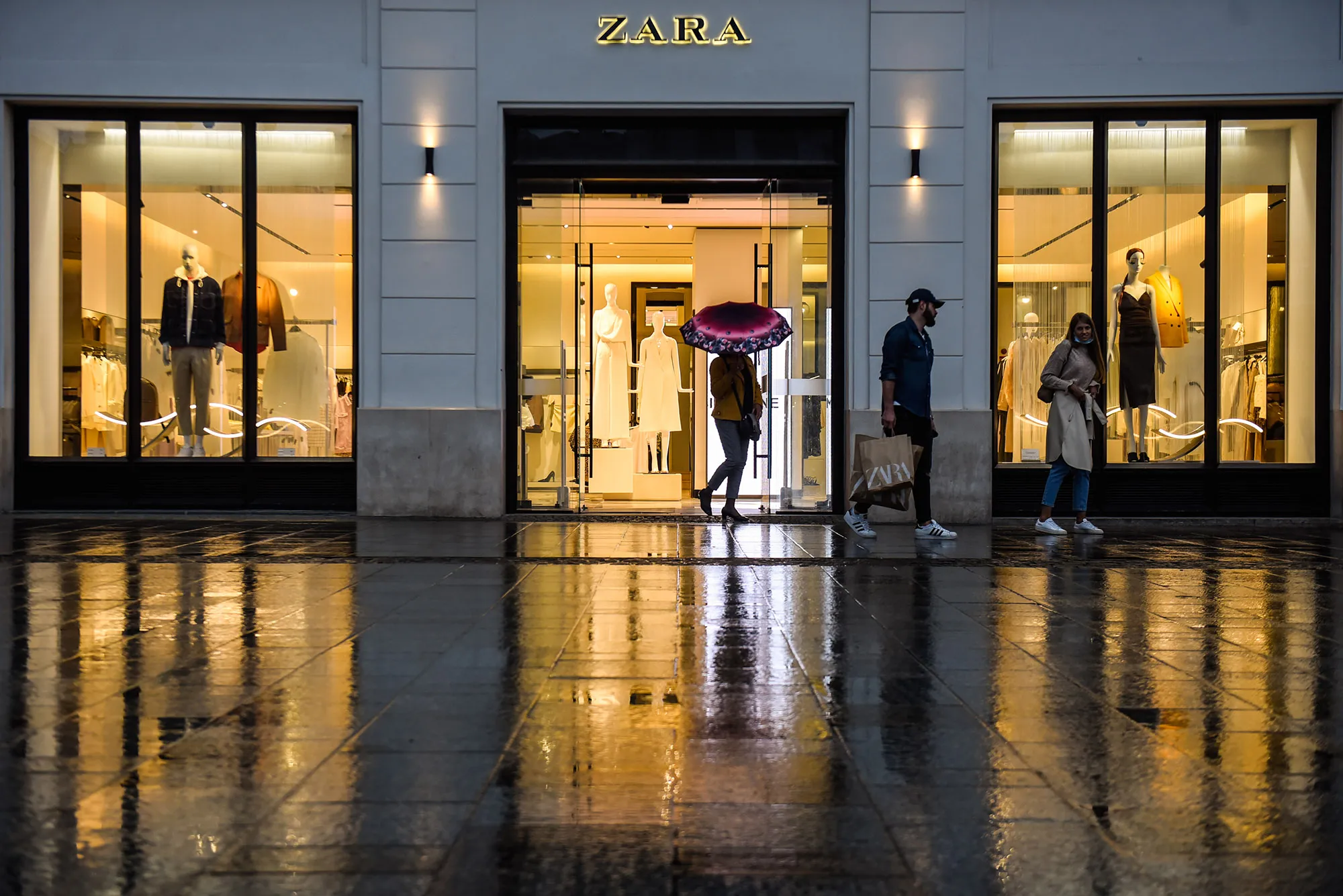 People exit an open clothing store Zara in Krakow, Poland, on April 29.
