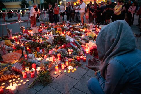 People mourn in Munich on July 23.