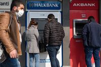 Customers use automatic teller machines in Istanbul.