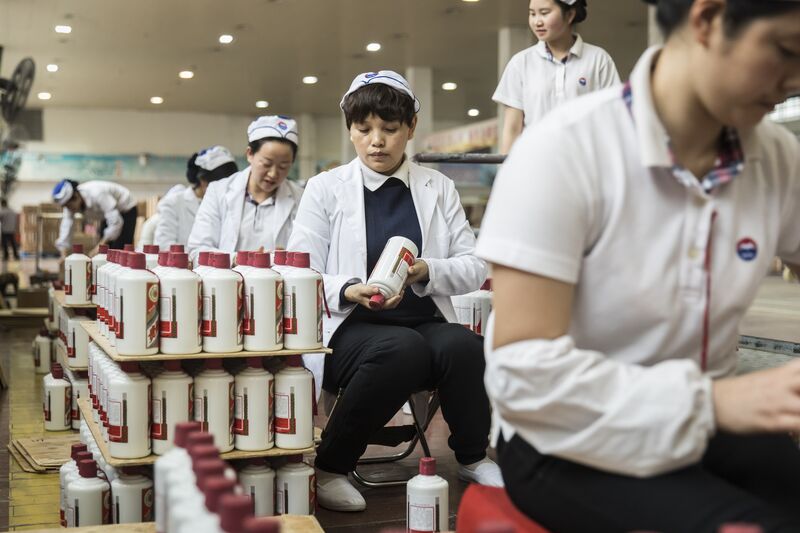 Employees arrange bottles of Moutai baijiu at the Kweichow Moutai factory in the town of Maotai in Renhuai, Guizhou province, China.