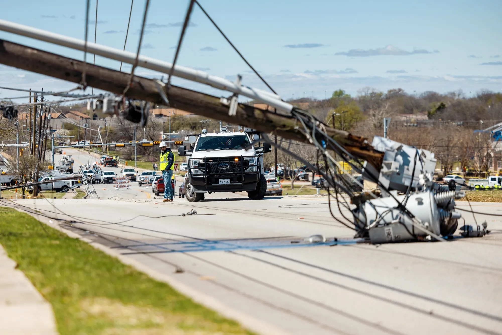Utility workers repair power lines following a tornado in Round Rock, Texas, on March 22.