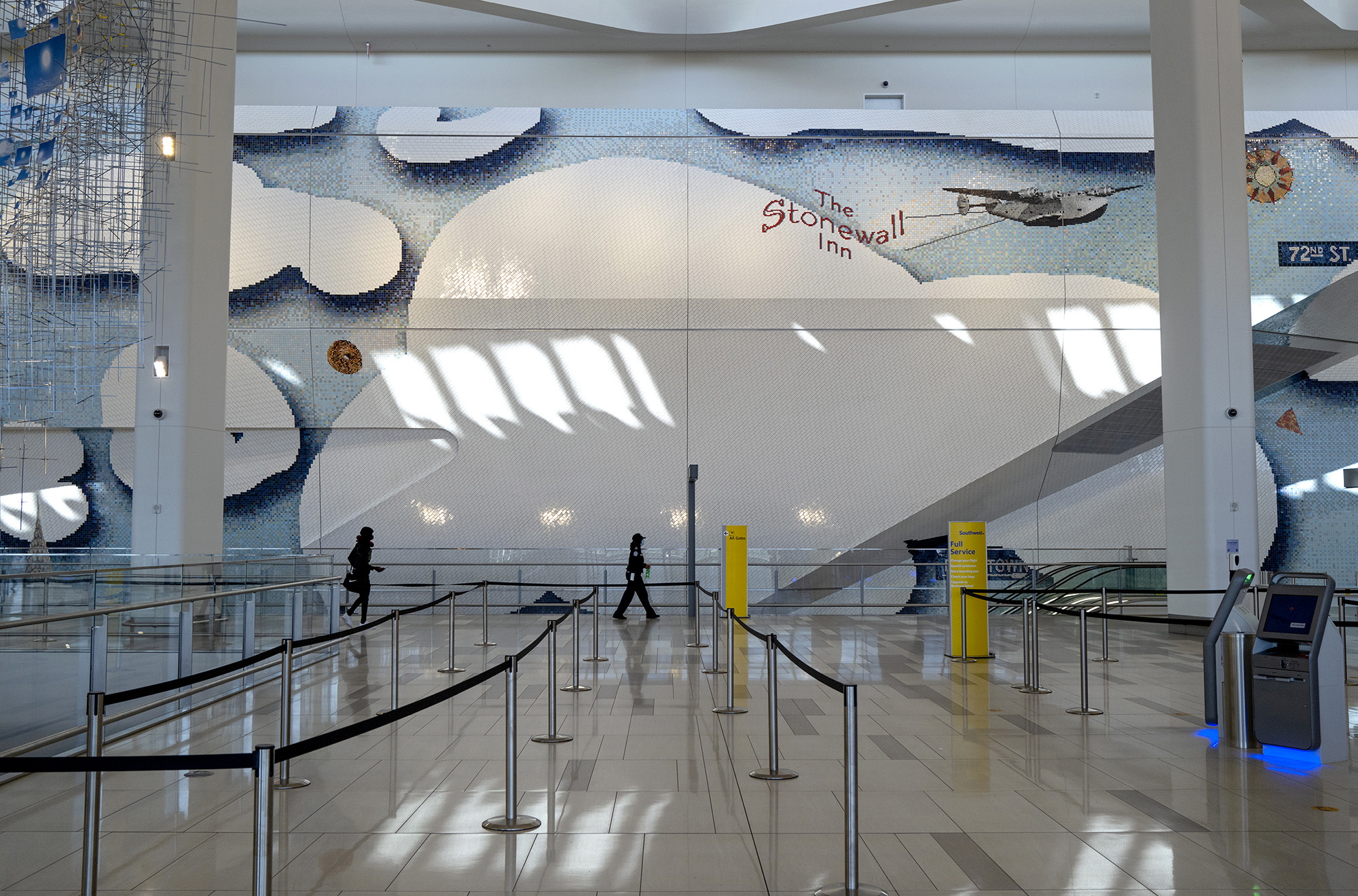 A mural depicting New York City themes by Laura Owens adorns an area of Terminal B at LaGuardia Airport in New York.