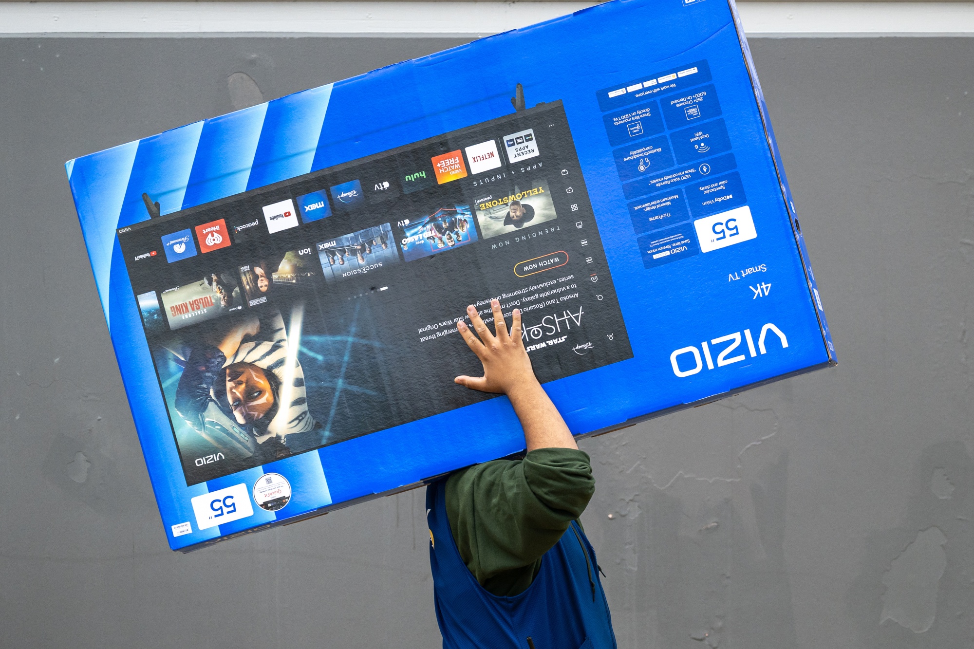An employee carries a Vizio television outside a Walmart store in Martinez, California, US, on Thursday, Nov. 20, 2025. Walmart Inc. increased its outlook for sales in the full year, a sign the world's biggest retailer is winning over price-sensitive shoppers and grabbing more digital spending.