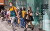 Shoppers wearing PPE (personal protective equipment), including a face mask as a precautionary measure against COVID-19, exit a re-opened Zara store in Grafton Street in central Dublin, Ireland on June 8, 2020.