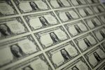 A 50 subject one dollar note sheets sits on an inspecting table after being printed by an intaglio printing press at the U.S. Bureau of Engraving and Printing in Washington, D.C., U.S., on Tuesday, April 14, 2015. Republican efforts to pass a fiscal year 2016 budget cleared another hurdle as the House named its members to a conference committee and Senate Majority Leader Mitch McConnell pledged to do the same by the end of the week.