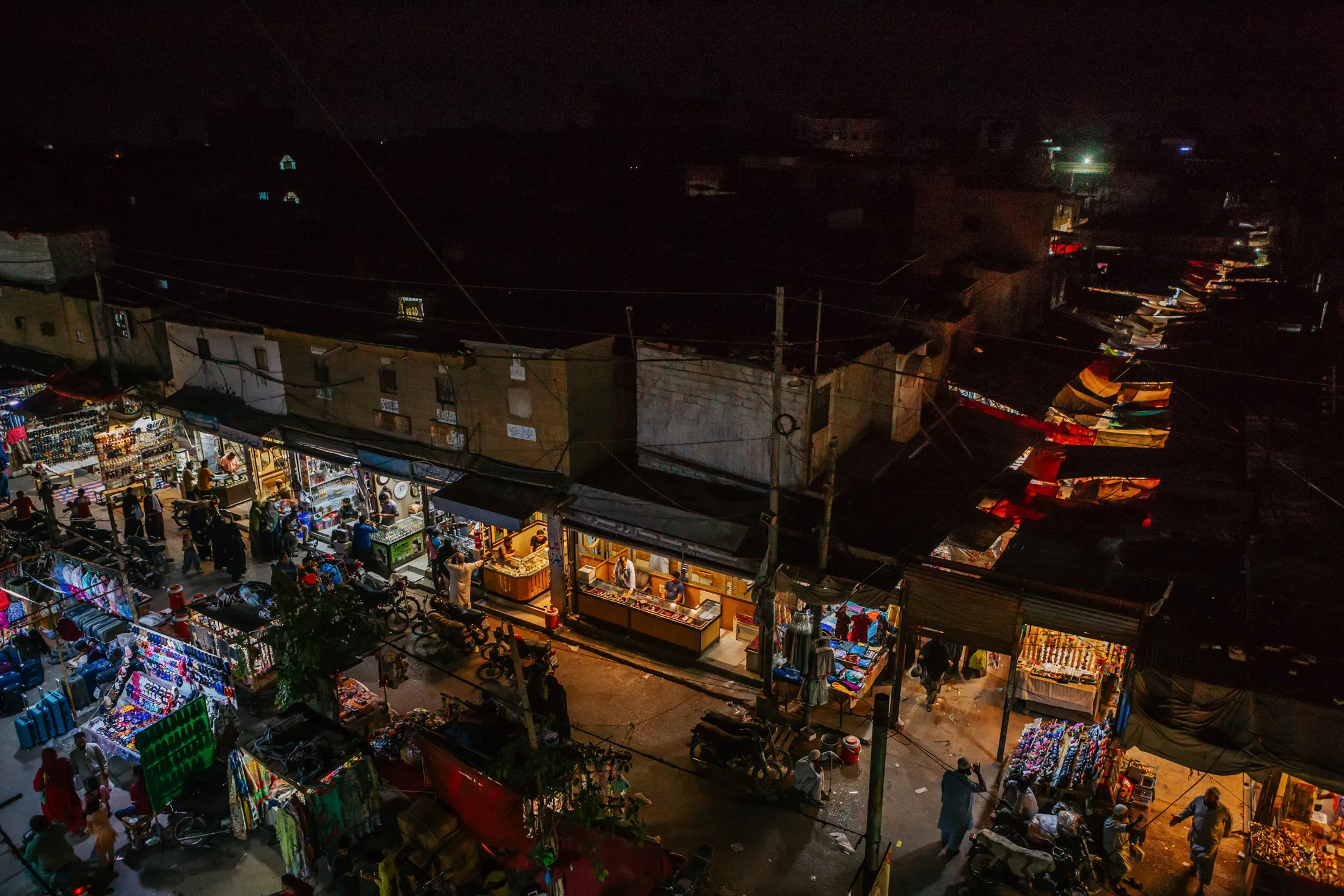 A&nbsp;local market illuminated by alternative power sources during a power outage&nbsp;in Karachi&nbsp;in May.