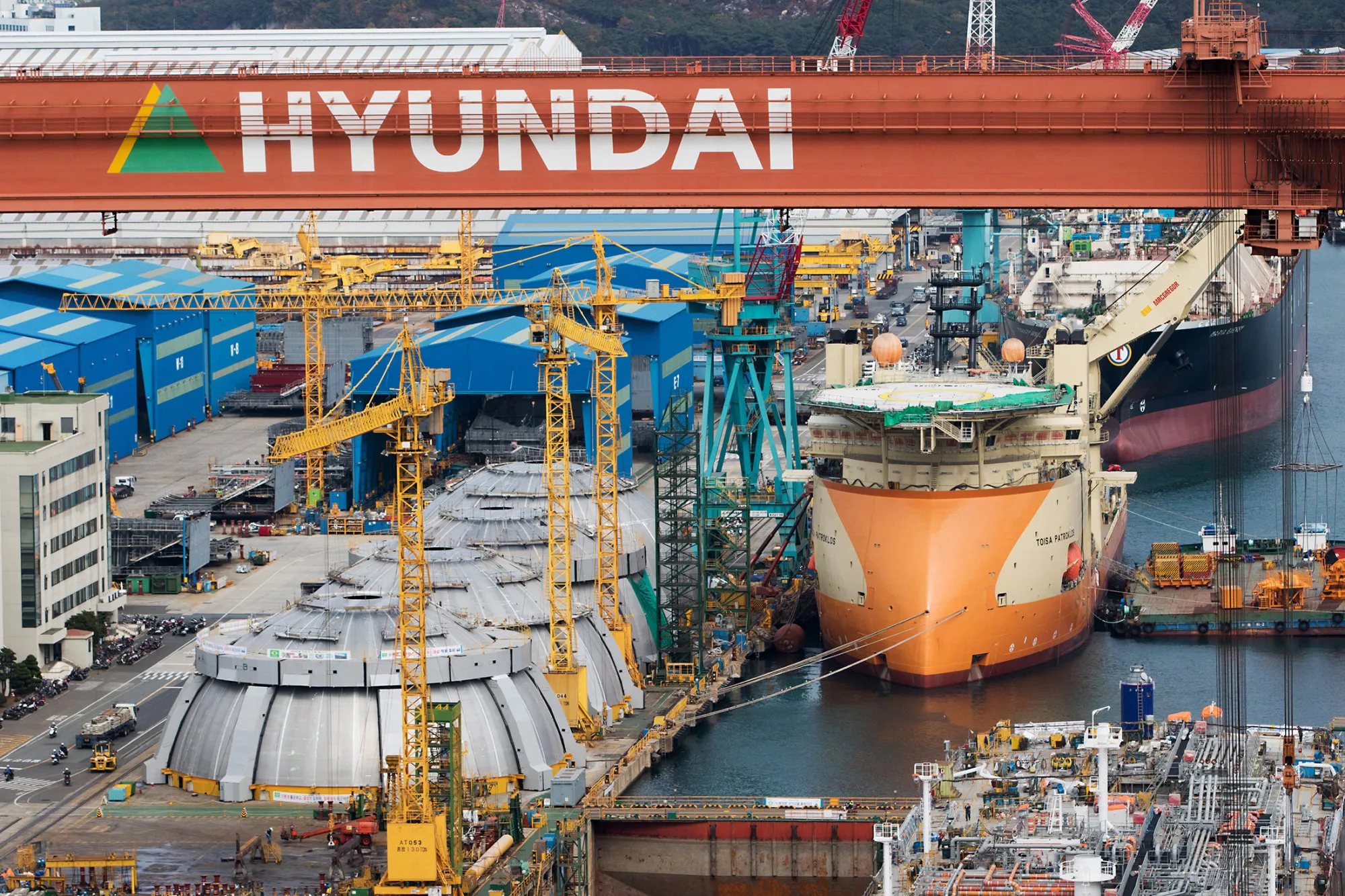 Ships under construction sit moored at the Hyundai Heavy Industries Co. shipyard in Ulsan, South Korea, on Tuesday, Nov. 10, 2015. Shipbuilding has been central to South Korea's economy since the 1970s. Ships accounted for 8.5 percent of the country's total exports through June 20 of this year, according to the trade ministry.
