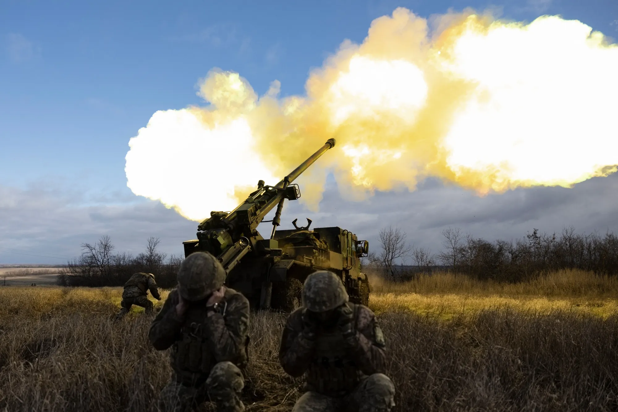 Ukrainian servicemen fire with a self-propelled howitzer towards Russian positions in eastern Ukraine.