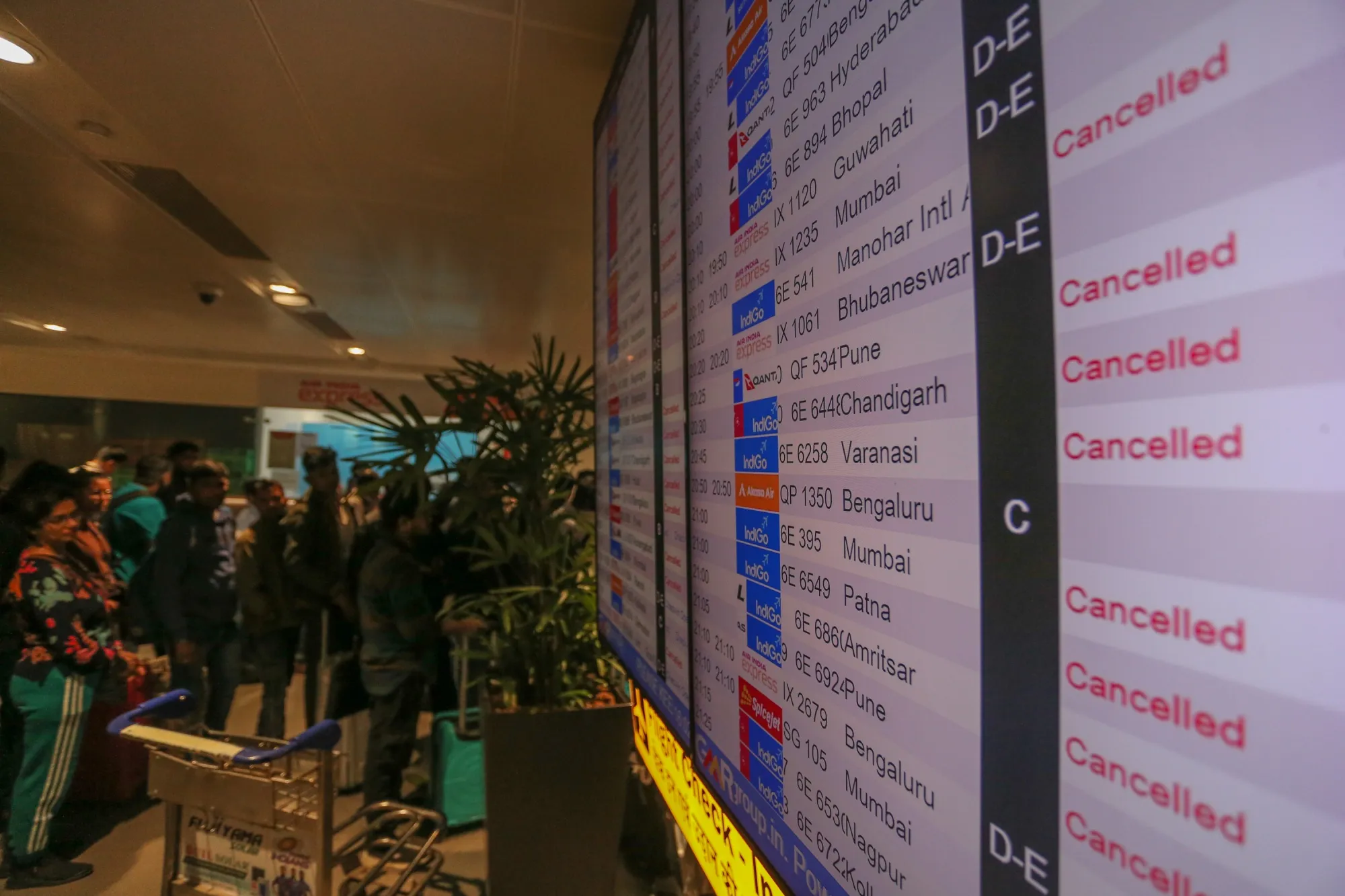 Passengers gather at the Indigo reservation counter at Indira Gandhi International Airport after mass cancellation of Indigo flights on Dec. 5, 2025 in New Delhi.