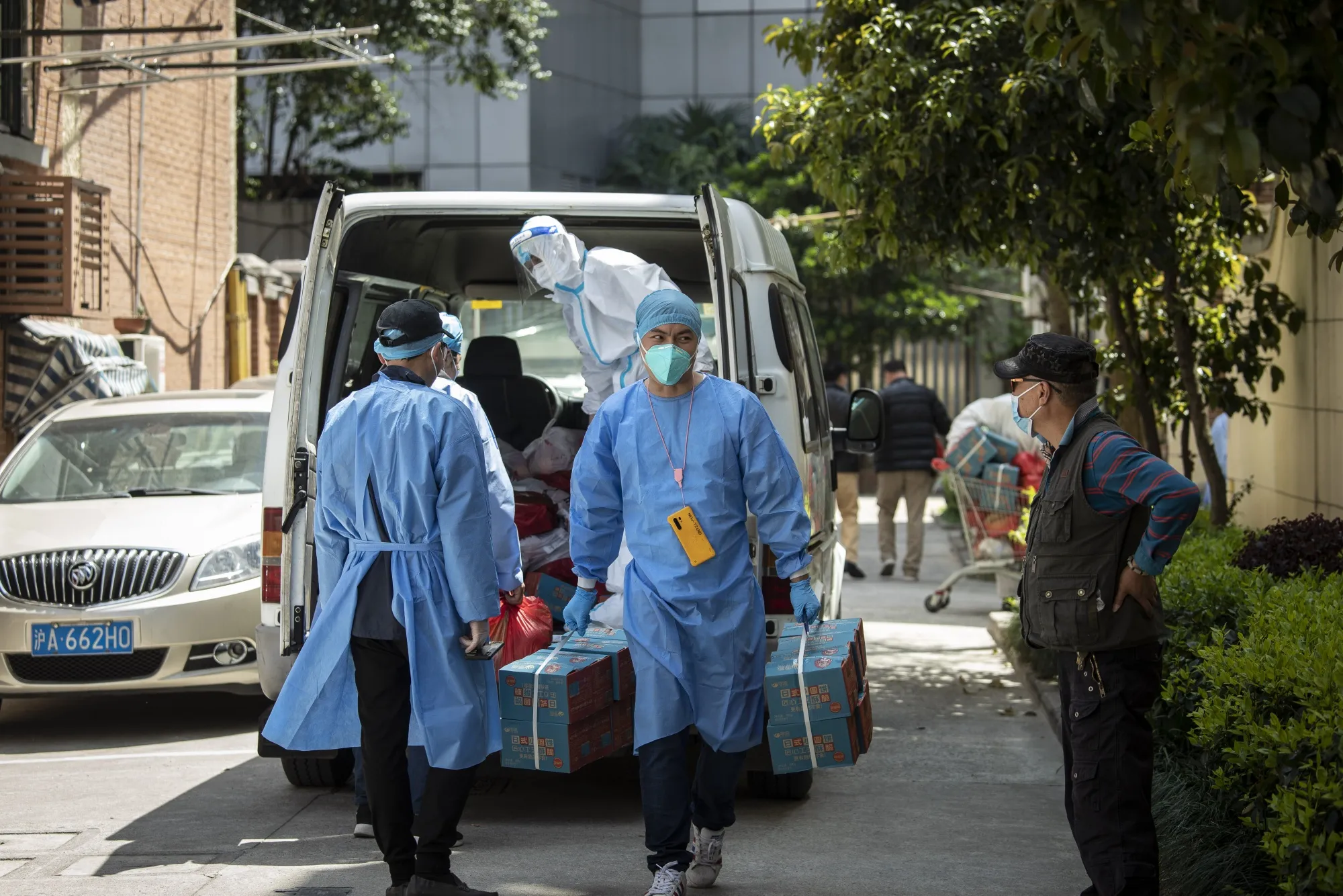Volunteers transport food supplies delivered by the government in Shanghai, on April 9.