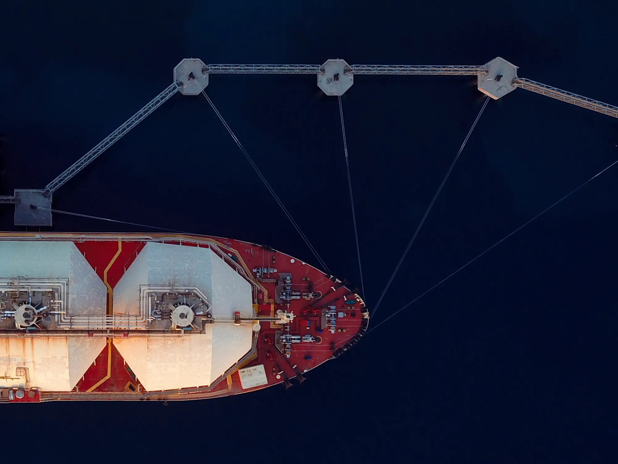 Aerial Top View Of A Liquefied Natural Gas (LNG) Tanker Moored To The Jetty