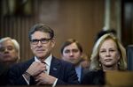 Rick Perry, former governor of Texas, sits with his wife Anita Thigpen Perry before the start of a Senate hearing in Washington on Jan. 19, 2017.