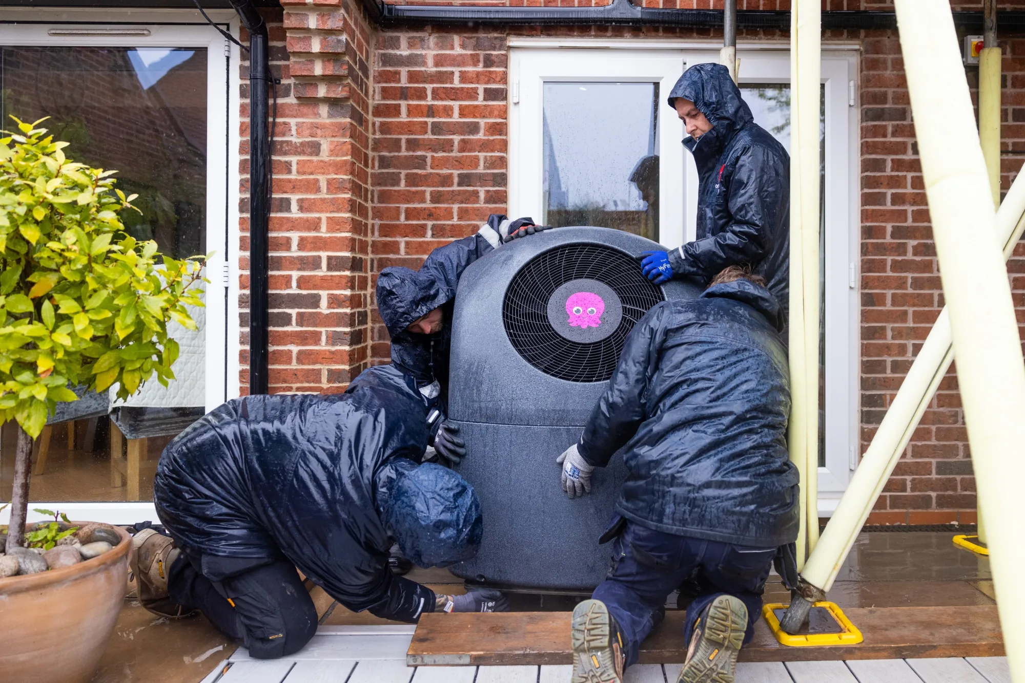 Engineers prepare to install an Octopus Energy Ltd. Cosy 6 heat pump at a residential property in Derby, UK.