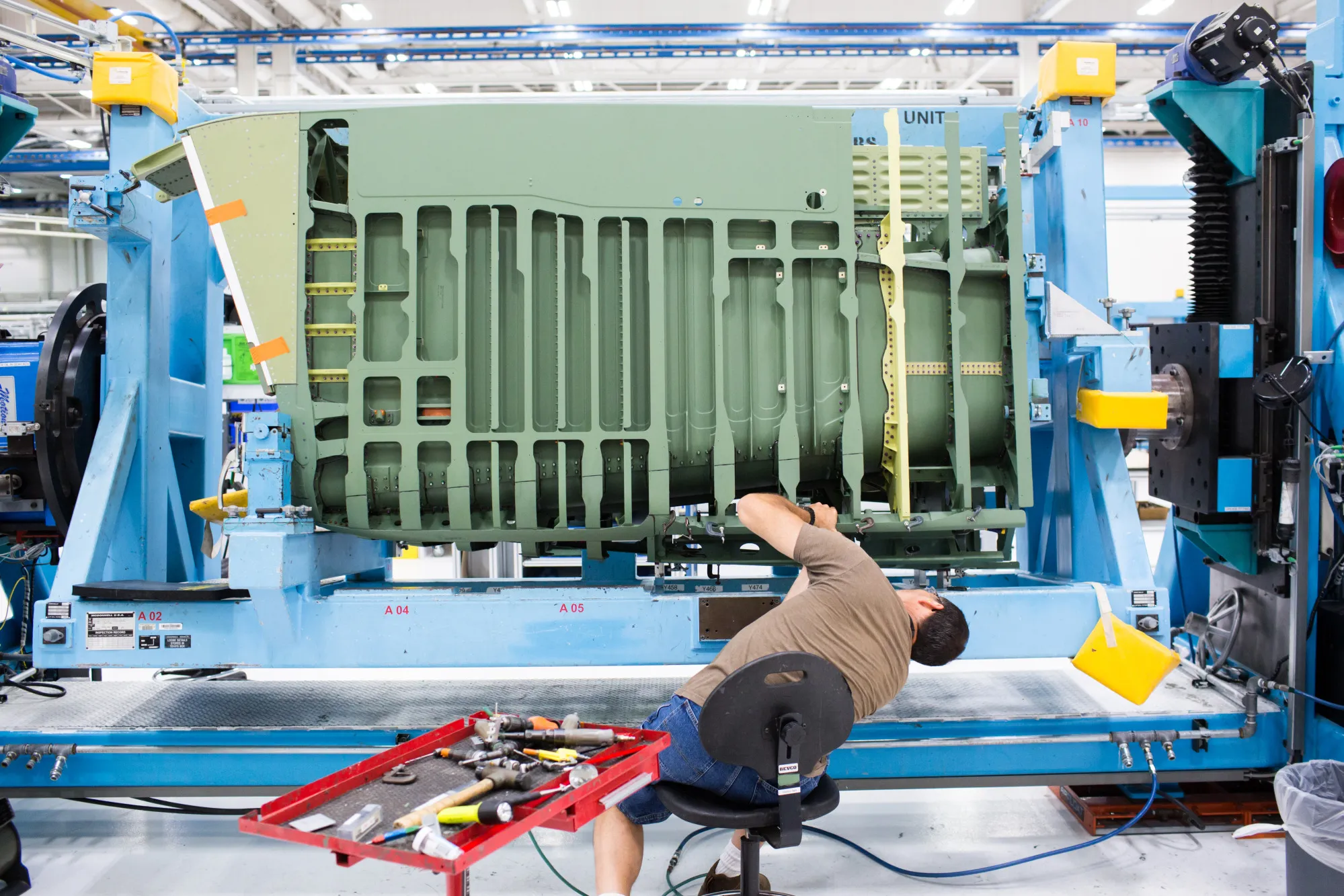 An employee works on the aft fuselage of a Boeing Co. F-15 Strike Eagle fighter aircraft at the Boeing Defense, Space &amp; Security facility in St. Louis, Missouri.