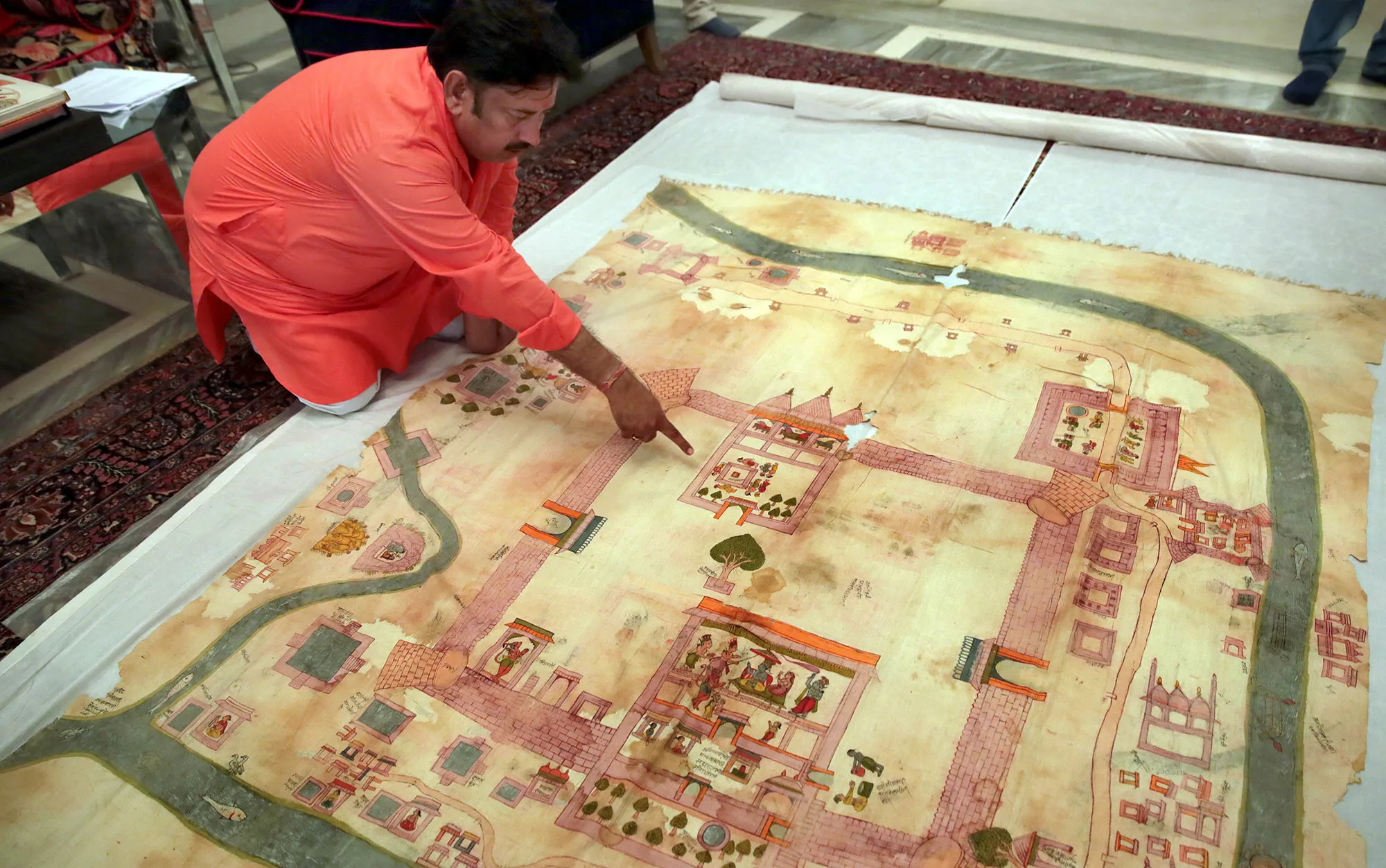 A man points to&nbsp;an old map of Ayodhya in Jaipur on Aug. 11, 2019.